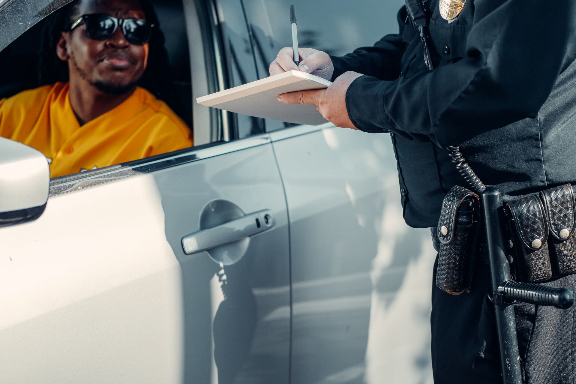 Police officer writing a citation during a roadside stop