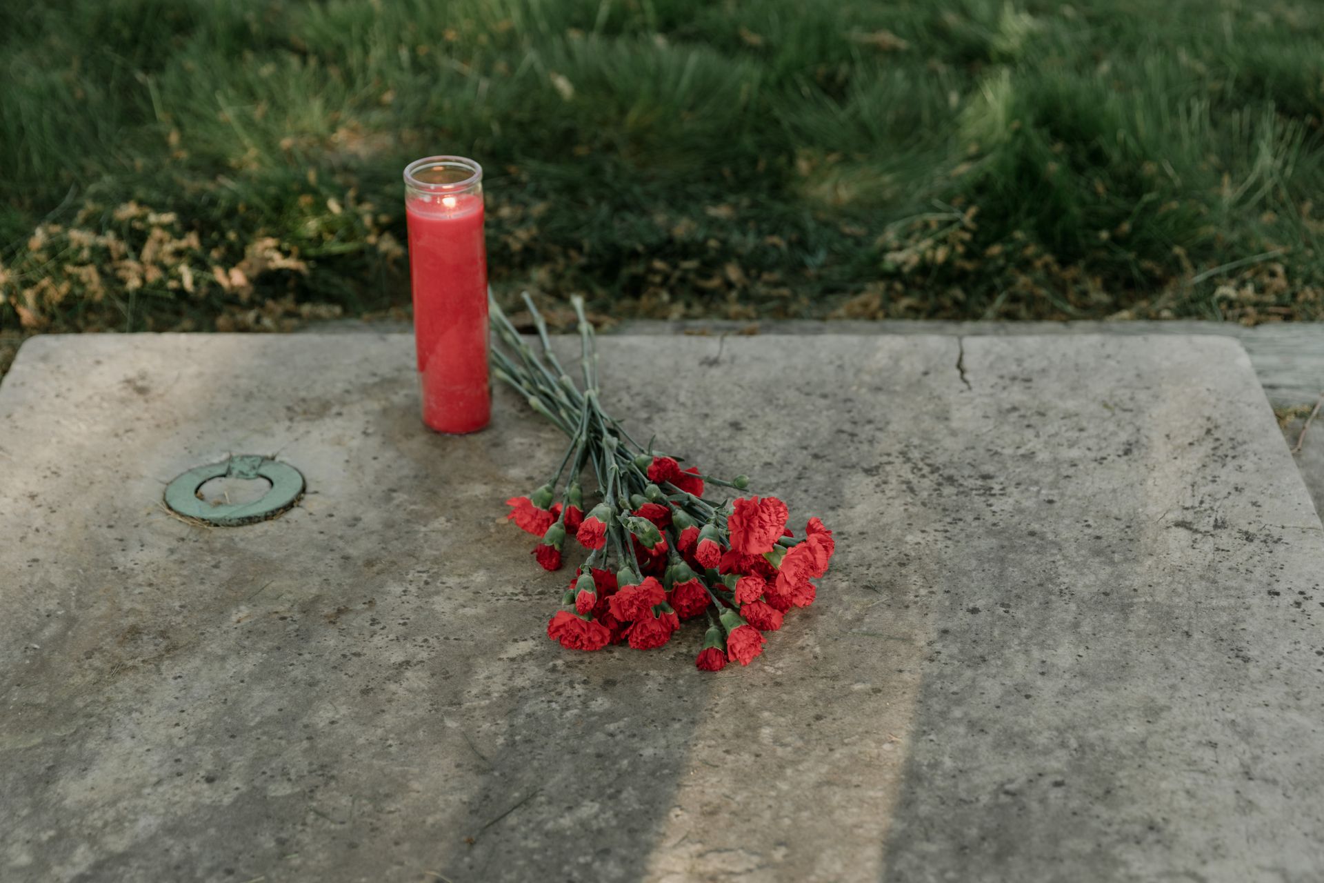 Flowers and a candle placed in remembrance